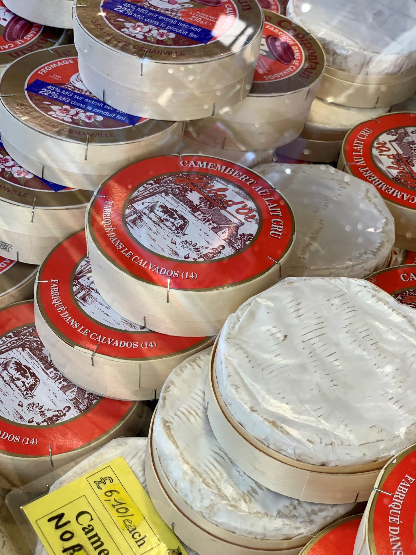 A close up of a display of wheels of camembert